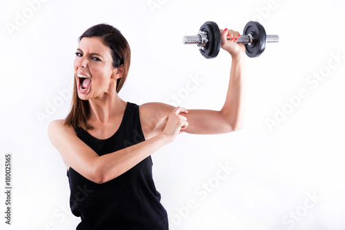 Young woman showing muscles