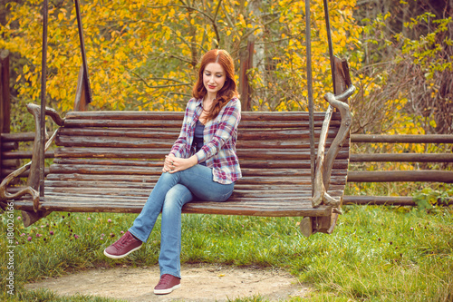 Beautiful hipster traveler with around autumn trees in woods. Stylish woman hiking. adventure and travel concept or rest at weekend on a nature, atmospheric moment