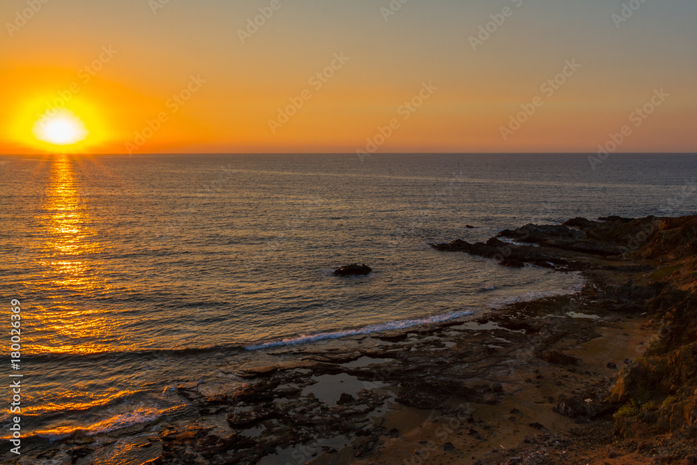 Sunset at a rocky beach in Pomos, Cyprus