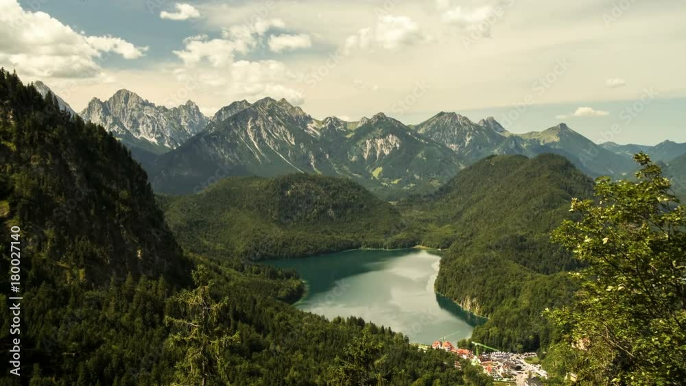 Time lapse clouds move over lake Alpsee near castle Neuschwanstein in the Bavaria Alps Germany Time lapse clouds move over lake Alpsee near castle Neuschwanstein in the Bavaria Alps Germany