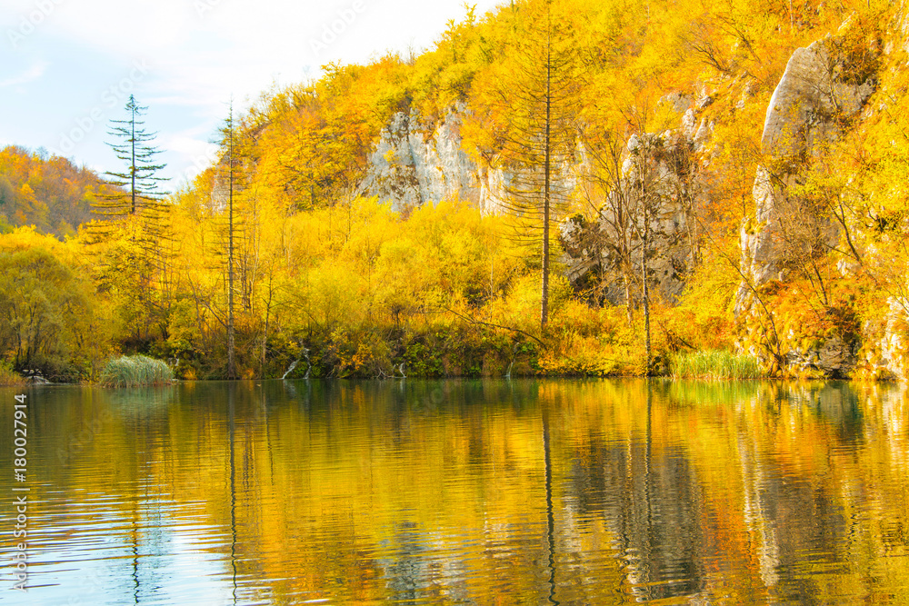 Colorful autumn landscape, trees reflecting on water on Plitvice Lakes National Park in Croatia 