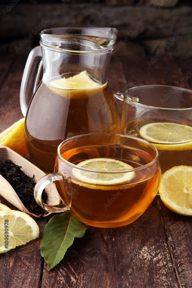 Hot tea in a transparent cup. Tea with lemon fruits. Warming drink Hot tea in a transparent cup. Tea with lemon fruits. Warming drink
