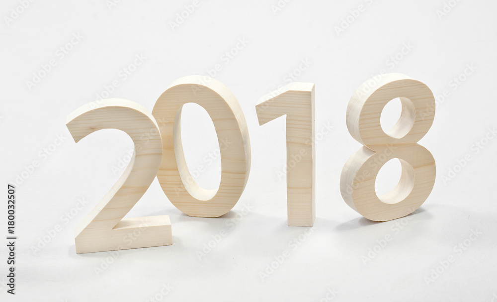 2018 Happy New Year, numbers cut from light wood on a gray background 2018 Happy New Year, numbers cut from light wood on a gray background