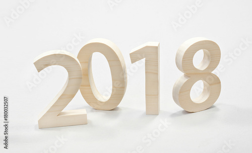 2018 Happy New Year, numbers cut from light wood on a gray background