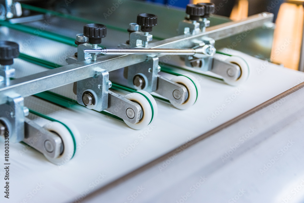 Paper Folding Machine Transfer Wheels Rollers Engineering Machinery Print Production Letter Sheet Moving Screws Adjustments Closeup Paper Folding Machine Transfer Wheels Rollers Engineering Machinery Print Production Letter Sheet Moving Screws Adjustments Closeup