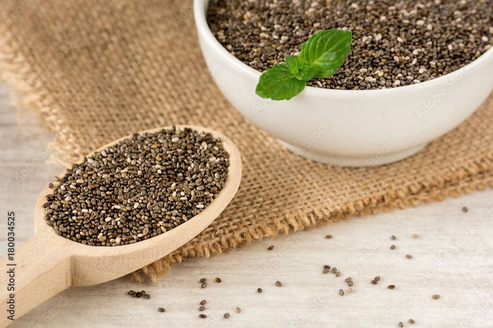 Wooden spoon filled with chia seeds. Wooden spoon filled with chia seeds.