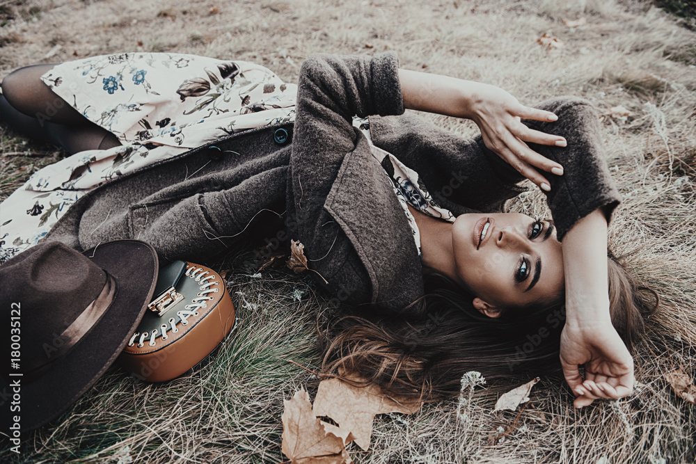 woman lying on the grass - obrazy, fototapety, plakaty 