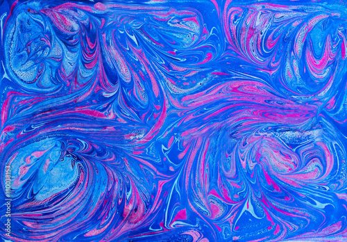 Abstract blue and pink pattern. Paper marbling in traditional turkish art style - ebru. Colorful art background texture. Handmade marble effect. 