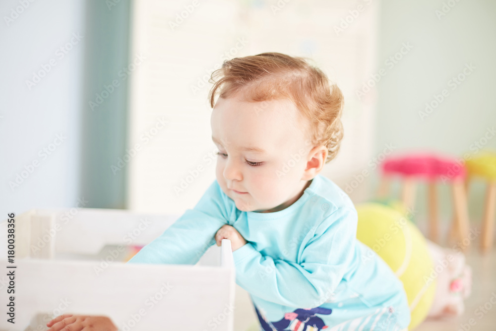 little child is playing with toys in the studio little child is playing with toys in the studio