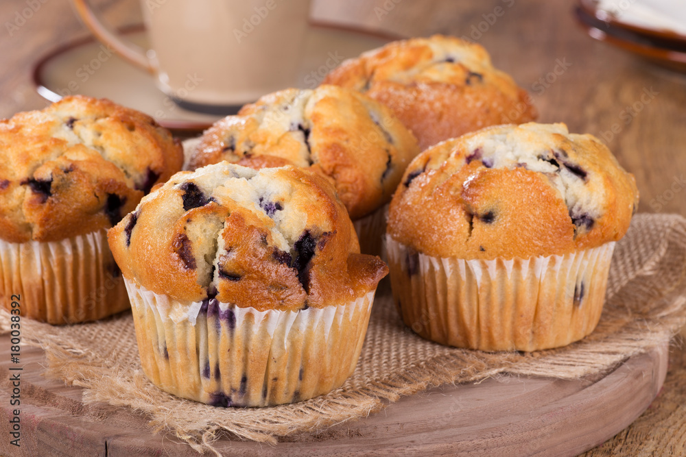 Golden Brown Blueberry Muffins on a Wooden Platter Golden Brown Blueberry Muffins on a Wooden Platter