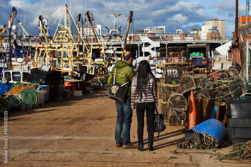 A couple lost in a port and fish market.