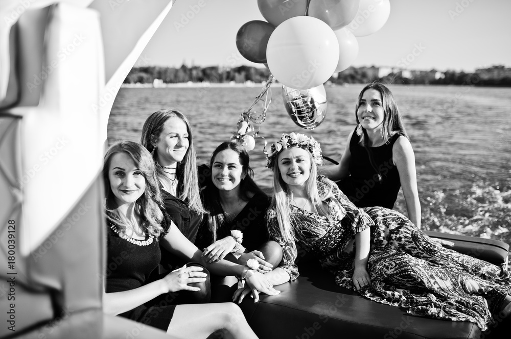 Obraz Five girls wear on black having fun at yacht against lake at hen party.