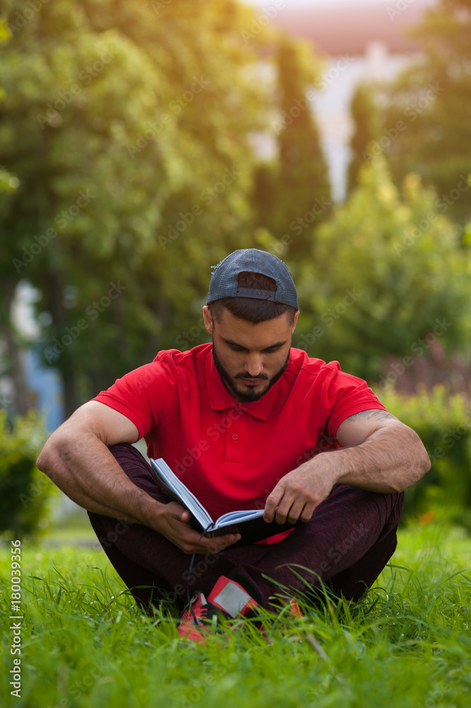 Young man wearing casual cloth reading book
