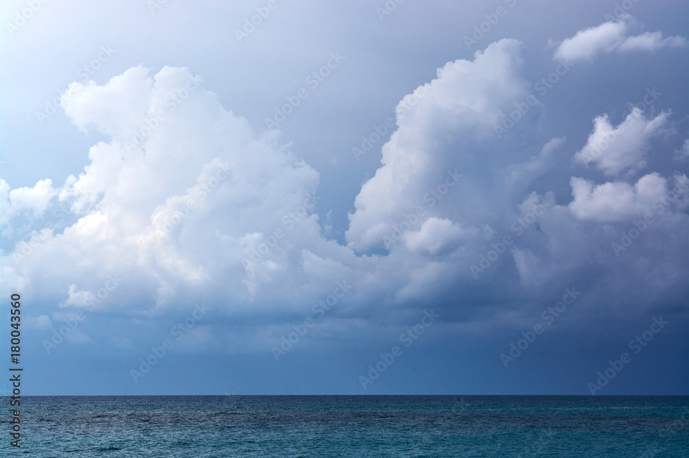 view from the shore to storm clouds over the sea