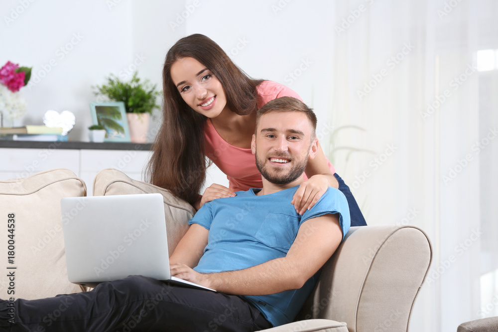 Young couple with laptop at home Young couple with laptop at home