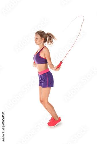 Sporty young woman jumping ...
