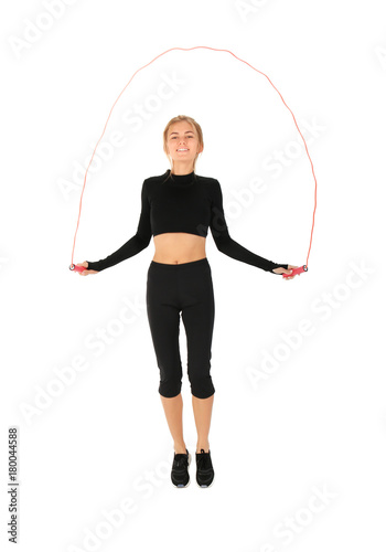 Sporty young woman jumping ...