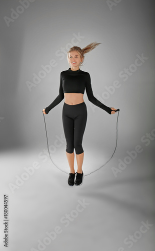 Sporty young woman jumping ...
