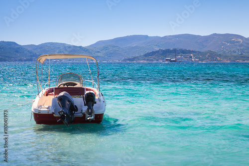 Pleasure motor boat anchored in bay photo