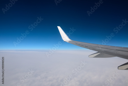 The wing of an airplane in a pure day sky. Between heaven and earth. Picture for add text message or frame website.