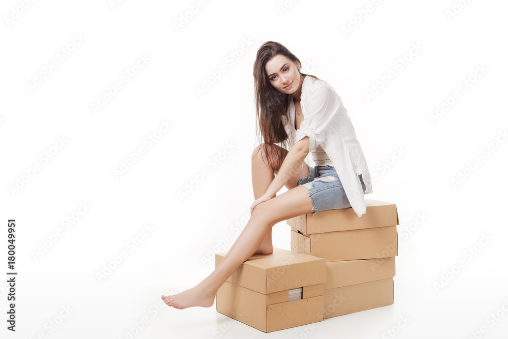 Sign people. Woman sitting on blank cardboard boxes. Casual young beautiful blonde model isolated on white background. Sign people. Woman sitting on blank cardboard boxes. Casual young beautiful blonde model isolated on white background.
