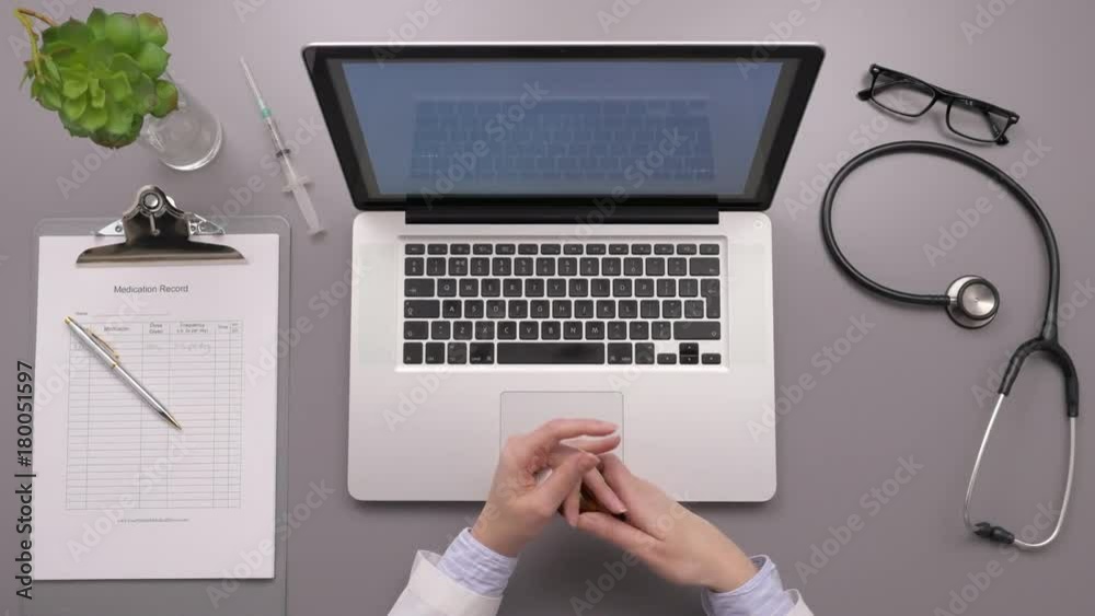 Overhead Shot Of Female Doctor Writing Prescription While Examining Pills Overhead Shot Of Female Doctor Writing Prescription While Examining Pills
