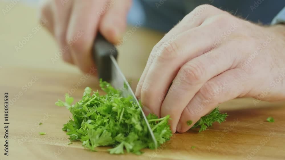 Man's Hands Cutting Cilantro With Knife On Chopping Board Man's Hands Cutting Cilantro With Knife On Chopping Board
