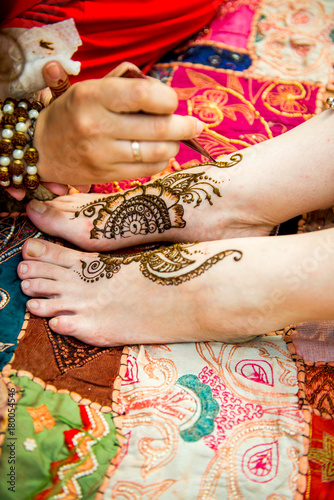 Picture of human hand being decorated with henna tattoo, mehendi © sushytska