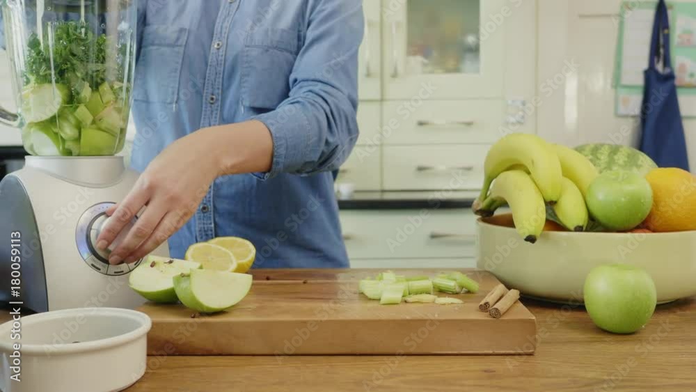 Woman Blending Healthy Green Fruits And Vegetables At Kitchen Woman Blending Healthy Green Fruits And Vegetables At Kitchen
