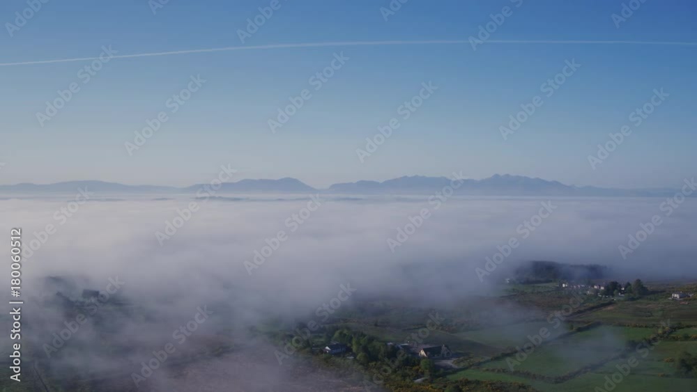 Aerial Drone Of Fields Covered With Clouds Against Vapor Trail Aerial Drone Of Fields Covered With Clouds Against Vapor Trail