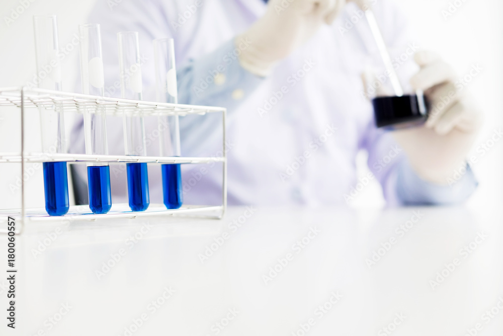 scientist stirs reagents beaker in Science Laboratory scientist stirs reagents beaker in Science Laboratory