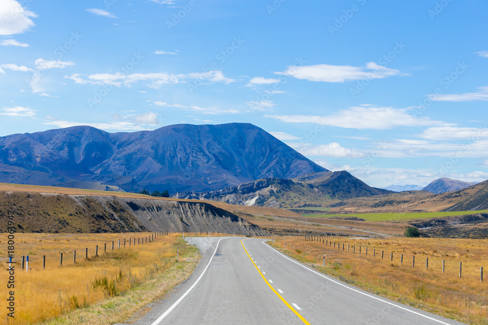 Rural Scene of Asphalt Road with Meadow and Mountain Range, South Island, New Zealand	