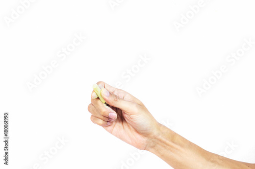 Hand holding chalk writing something text on empty space. Isolated on white background. Chalk is used to write text on a blackboard. Chalk made of plaster