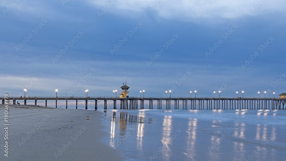 Beach pier during dawn twilight