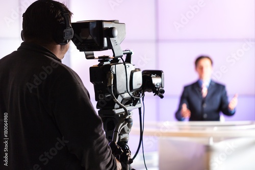 Closeup of a Camera Operator Filming an Anchorman © BillionPhotos.com