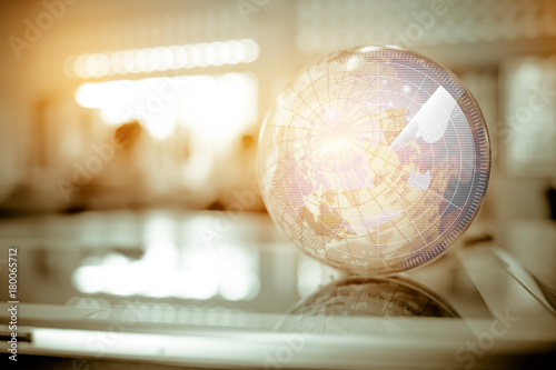 Earth globe model ball map with Radar background on tablet in classroom. Concept for global international educaiton or communications, politics environmental for learning world wide. vintage tone photo