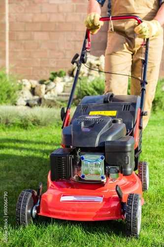 Closeup of a Gardener Using a Lawn Mower