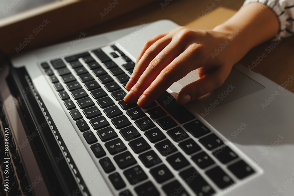 Working at cafe with laptop woman writing a blog. Female hands on the keyboard Working at cafe with laptop woman writing a blog. Female hands on the keyboard