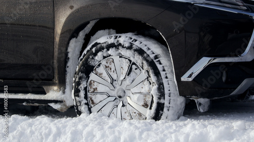 Front wheel of vehicle got stuck in the deep snow detailed photo   