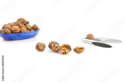 Isolated composition of healthy nuts, a nutcracker and a blue cup photo