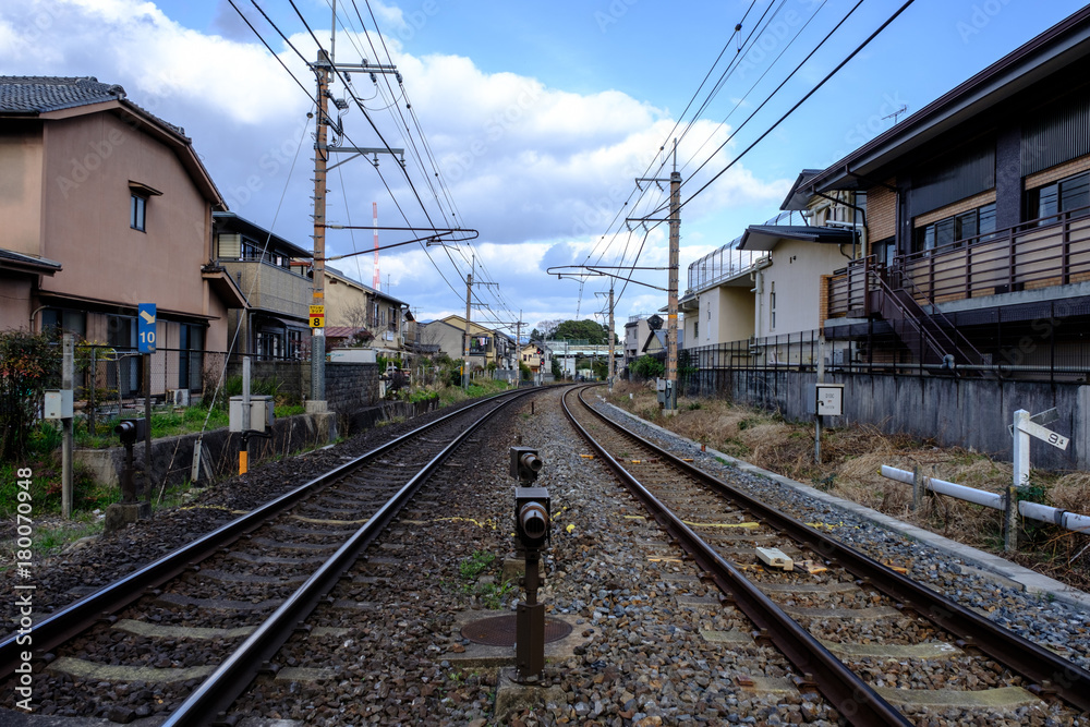 Railroad tracks with Cityscape and cloudy sky in Japan