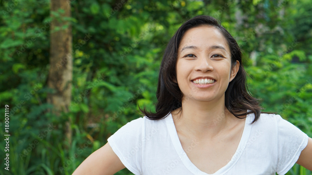 Asian woman long hair with facial epression green nature background Asian woman long hair with facial epression green nature background