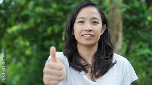 Asian woman long hair with facial epression green nature background photo