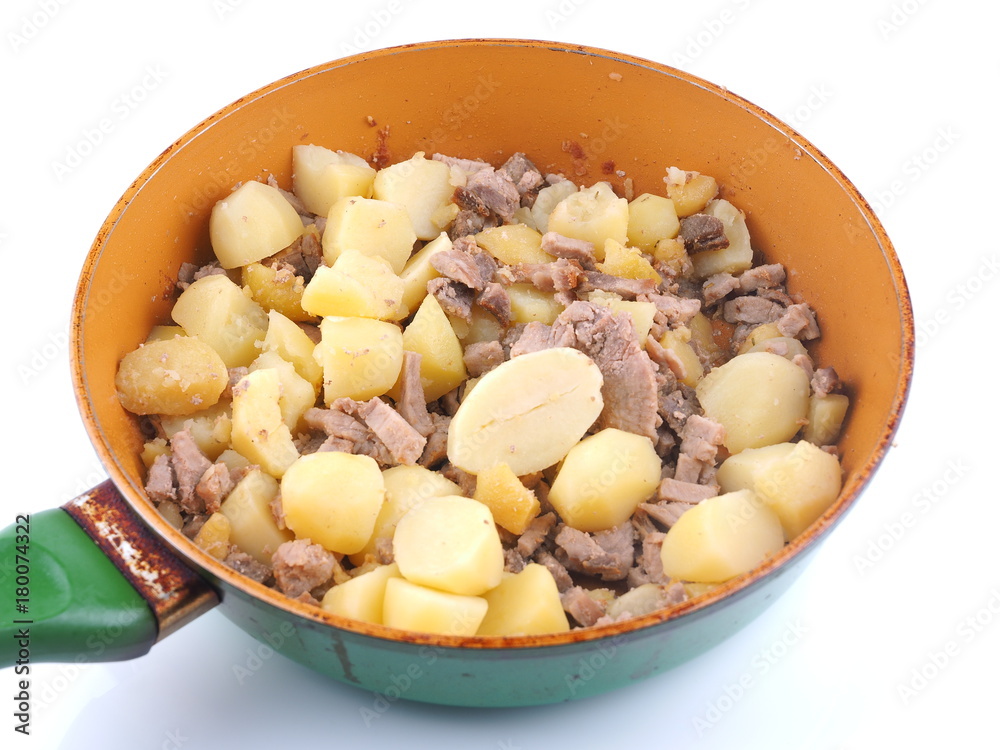 fried potatoes with meat in a frying pan fried potatoes with meat in a frying pan