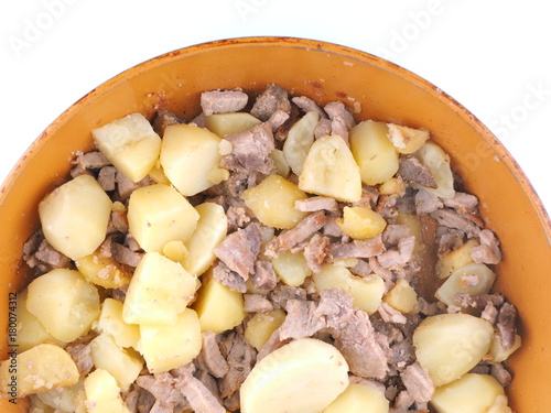 fried potatoes with meat in a frying pan