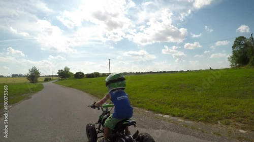 A little boy rides his electric ATV quad.
A boy enjoys a ride on a quad.