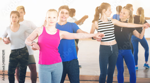Group of teen dancing salsa in dance studio