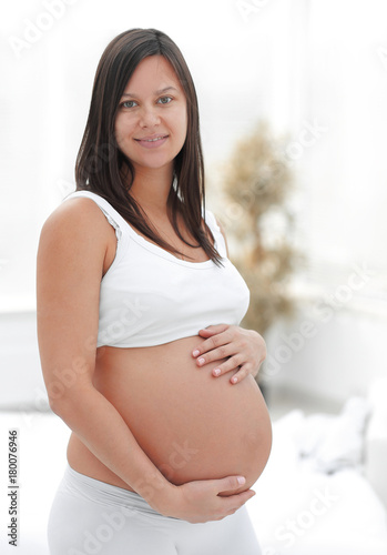 portrait of young pregnant woman on a light background. Free Download portrait of young pregnant woman on a light background. - GFXLoad