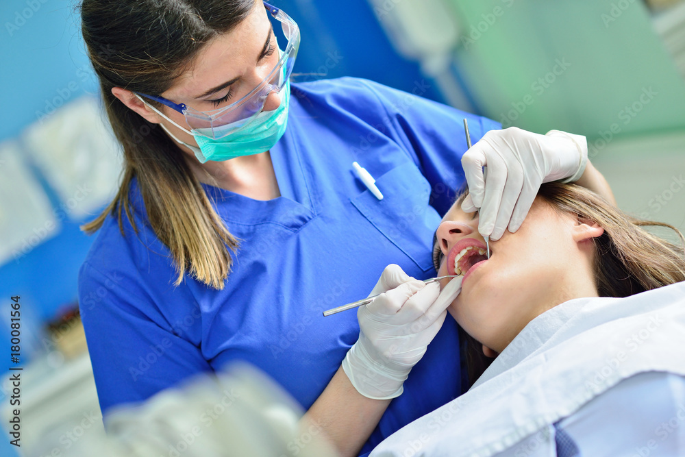 people, medicine, stomatology and health care concept - happy female dentist checking patient girl teeth people, medicine, stomatology and health care concept - happy female dentist checking patient girl teeth