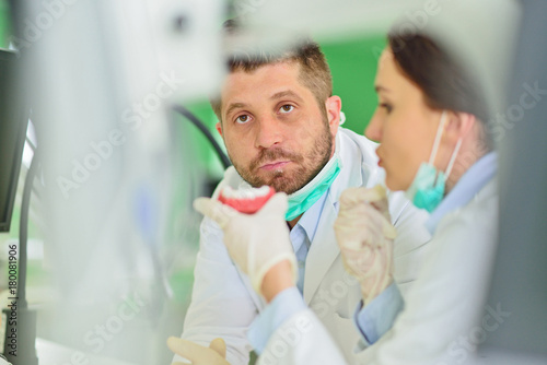 Dental prosthesis  dentures  prosthetics work. Prosthetics hands while working on the denture